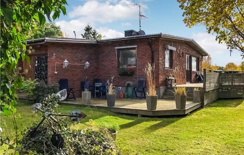 a brick house with a patio in a yard at 3 Bedroom Cozy Home In Svanesund in Svanesund