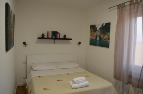 a bedroom with a bed with two towels on it at Casa SoleLuna - alloggio turistico Rome Airport in Fiumicino