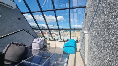 a balcony with two blue and white chairs in a building at Central Hotel in Lviv