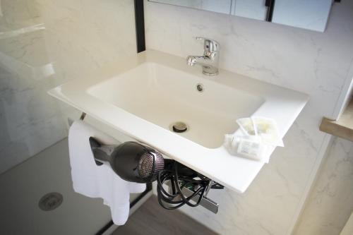 a bathroom with a white sink and a mirror at Residence La Quiete in Alba