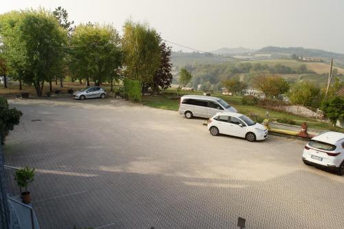a parking lot with three cars parked in it at Residence La Quiete in Alba