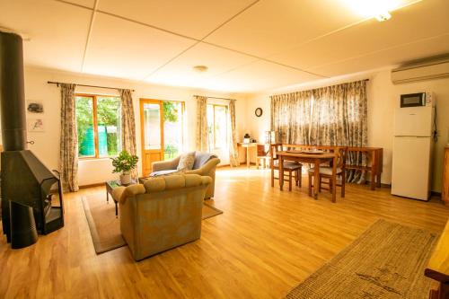 ein Wohnzimmer mit einem Sofa und einem Tisch in der Unterkunft Garden Cottage in Graaff-Reinet