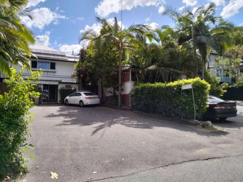 a white car parked in front of a house at cliffinn kangaroo point in Brisbane