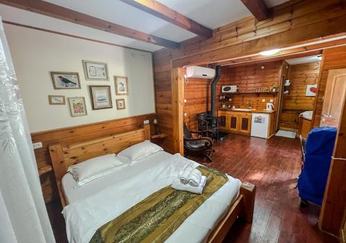 a bedroom with a bed in a room with wooden walls at לבנון ברמות in Moshav Ramot