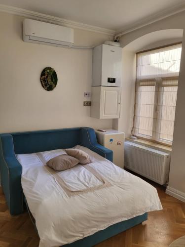 a bed with a blue headboard in a bedroom at Fancy Flats in Sibiu