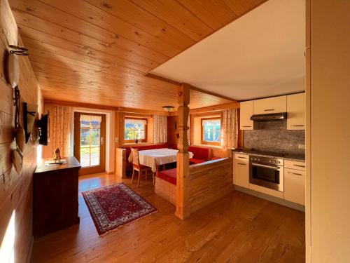 a kitchen and dining room of a log cabin at Fürstenhof in Zell am Ziller