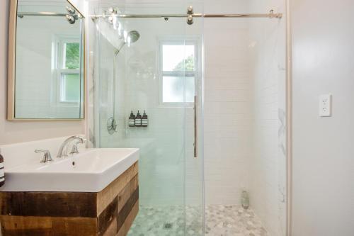 a white bathroom with a sink and a shower at Boston Queen Bedroom in Boston