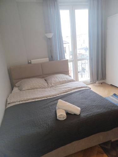 a bed with a white shoe sitting on top of it at APARTAMENTY CENTRUM Lipowa 16 in Białystok