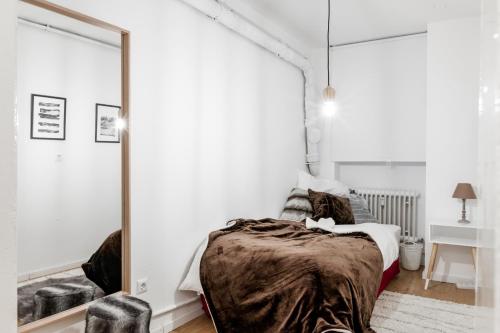 a bedroom with a bed and a large mirror at Beautiful 3 Room apartment in Kreuzberg in Berlin