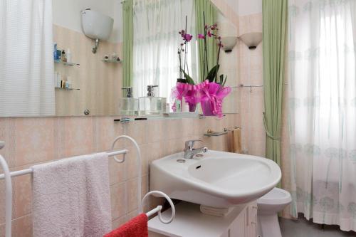 ローマにあるA Casa di Silvanaのバスルーム(洗面台、トイレ、鏡付)