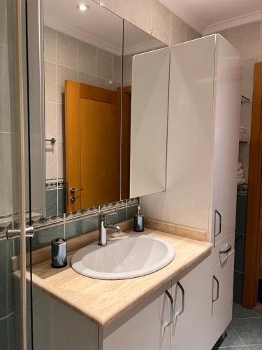 a bathroom with a sink and a mirror at Secure, Spacious, and Eclectic 1 to 3 Bedroom Apartments w Pool, Garden, Private Parking, Tennis Basketball Football Courts and Concierge close to Istinye Park, Turkish Tennis Federation, and Acibadem Maslak in Istanbul
