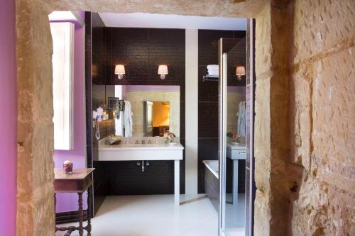 a bathroom with a sink and a mirror at Château de Noizay - ChâteauZen in Noizay