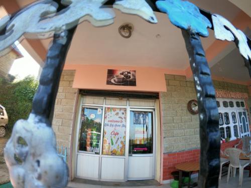 a building with a giraffe statue in front of it at Ritu Raj Home Stay & Cafe in Malther