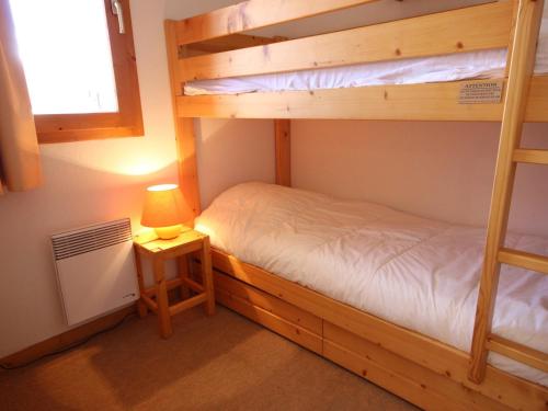 a bedroom with two bunk beds and a lamp at Appartement Peisey-Vallandry, 3 pièces, 6 personnes - FR-1-411-648 in Landry