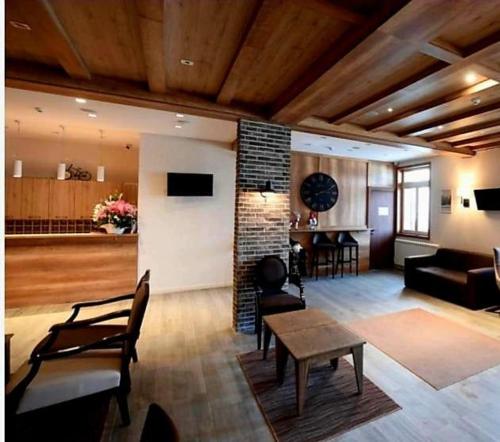 a living room with a couch and a table at VS Apartman , Hotel Župa Kopaonik in Kopaonik