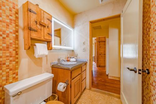 a bathroom with a sink and a toilet and a mirror at El Nido The Nest in Arcata