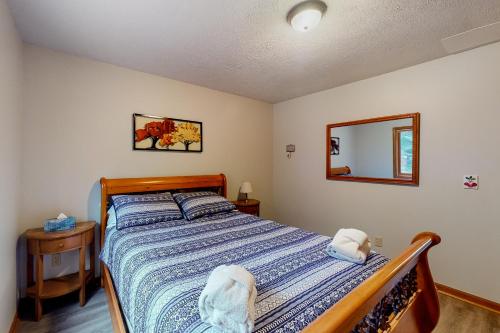 a bedroom with a bed and a mirror on the wall at Creeping Snails in Glen Arbor
