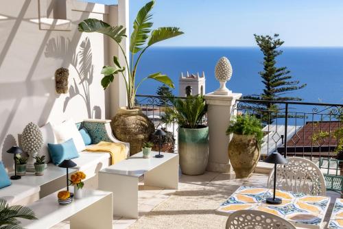 a patio with a view of the ocean at Taodomus Small Boutique Hotel in Taormina