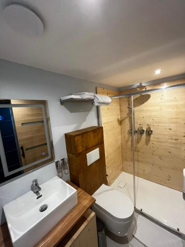 a bathroom with a sink and a toilet and a shower at 9WAGRAM Hotel Boutique in Le Mans
