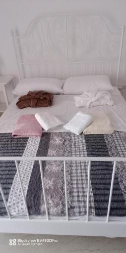 a white bed with blankets and pillows on it at Trikala center in Tríkala