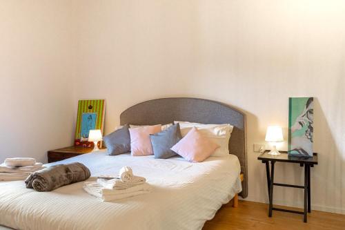 a bedroom with a large bed with towels on it at Dimora Casina dell'abbondanza in Gubbio