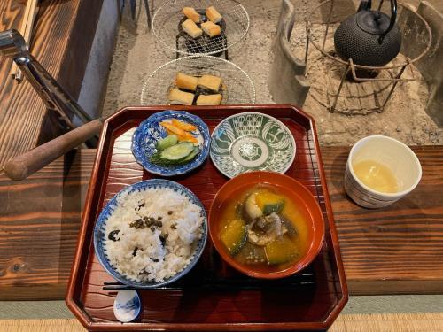 a tray of food with rice and bowls of food at 一汁一菜の宿 ちゃぶダイニング Ichiju Issai no Yado Chabu Dining, A Private Farmstay in Rural Kyoto in Ayabe