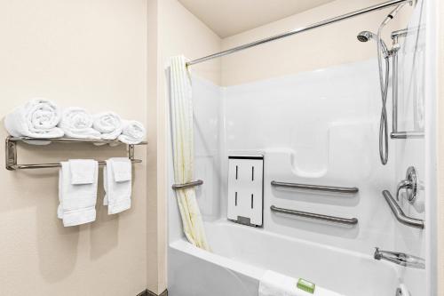 a bathroom with a tub and a shower with towels at Cobblestone Hotel & Suites - Superior Duluth in Superior