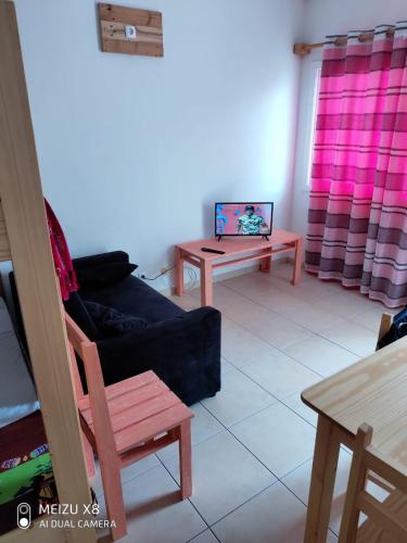 a living room with a couch and a table at Atlantic Sal Hostel in Santa Maria