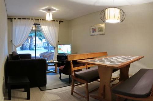 a living room with a chess board on a table at Apart Hotel Gran Pacifico in La Serena