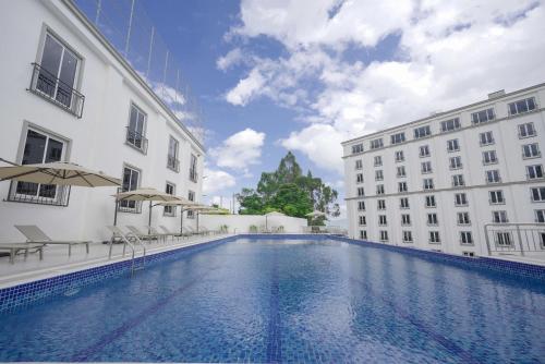 a swimming pool in the middle of two buildings at Haile Grand Addis Ababa in Addis Ababa
