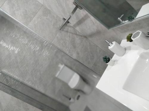 a bathroom with a sink and a toilet and a mirror at Lisbon, 3 bedroom apartment in Amora , 15 min from the beach in Amora