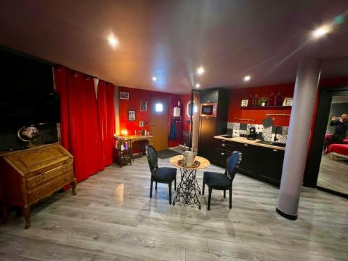 une pièce avec une table et des chaises et une cuisine dans l'établissement L'Escape, à Calais