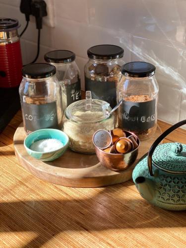 a wooden tray with jars of food on a table at Beaumont Family Wines in Botrivier