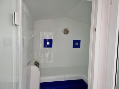 a white bathroom with a shower and a tub at Meerblick 424 im Haus Trafalgar in Cuxhaven