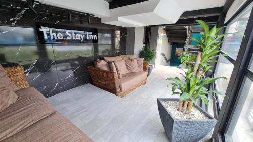 a living room with two couches and a tv at The Stay Inn in San José