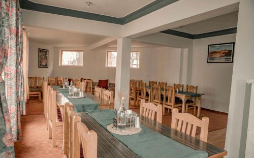 a dining room with a long table and chairs at zikzik holidays in Leh