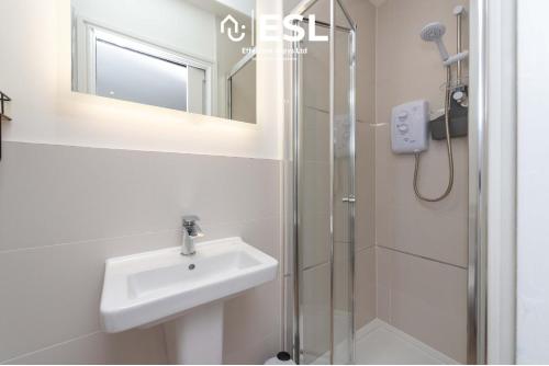 a bathroom with a sink and a shower at Studio 3, Top Floor Town Centre Apartment in Shrewsbury