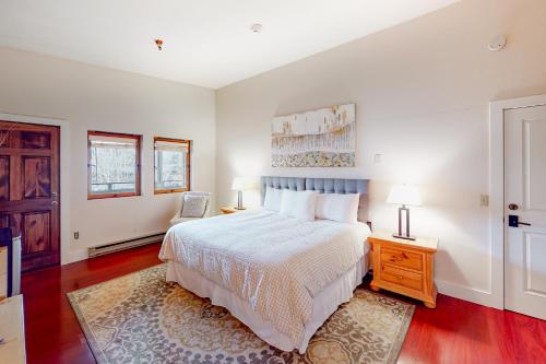 a bedroom with a white bed and a wooden floor at Ketchum Getaways in Ketchum