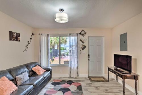 a living room with a couch and a television at Ideally Located West Palm Beach Apartment! in West Palm Beach