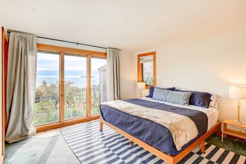 a bedroom with a bed and a large window at Serene Jonesport Escape Deck with Water Views! in Jonesport
