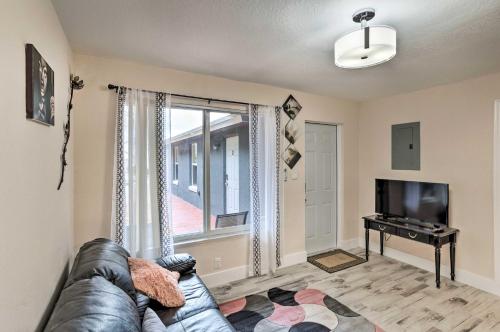 a living room with a couch and a television at Ideally Located West Palm Beach Apartment! in West Palm Beach