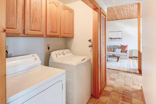a kitchen with a washing machine and a living room at Serene Jonesport Escape Deck with Water Views! in Jonesport