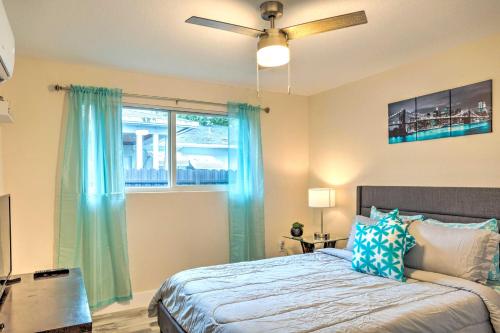 a bedroom with a bed with blue curtains and a window at Turquoise Escape about 1 Mi to Sailfish Marina! in West Palm Beach