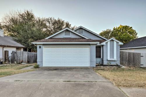 a house with a white garage in a yard at Gorgeous Austin Getaway with Fire Pit about 8 Mi to Dtwn in Austin