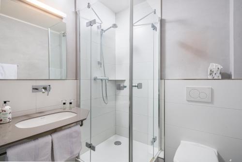 a bathroom with a shower and a sink at Hotel Görtler in Seesen