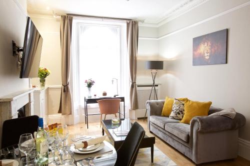 a living room with a couch and a table at Avari Apartments - Winchester Collection in London
