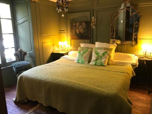 a bedroom with a bed with white sheets and pillows at Domaine De La Bastille in Saint Malo