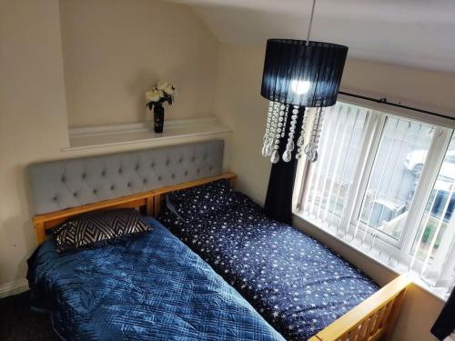 a bedroom with a bed and a window at Cheerful 2-bedroom home with off street parking in Blackpool