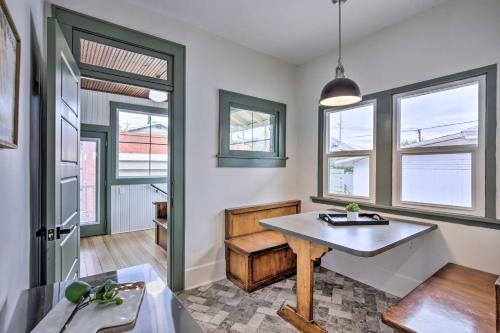 a living room with a table and some windows at El Paso Historic Craftsman House Less Than 1 Mi to Dtwn! in El Paso