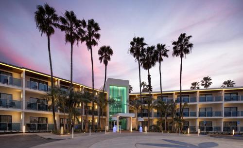 a building with palm trees in front of it at Marina del Rey Hotel in Los Angeles